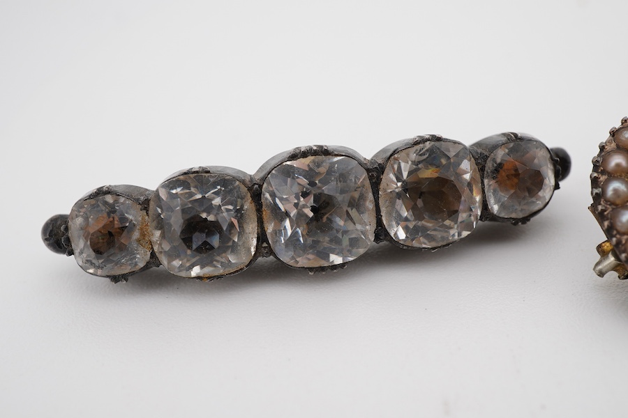 Assorted jewellery including a 19th century mourning brooch with plaited hair and split pearl set border, 22mm, a yellow metal mounted tooth, three marcasite set items and a paste set brooch.